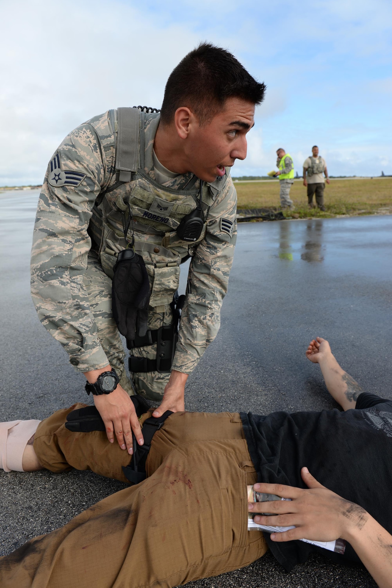Senior Airman Nicholas Moreno, 36th Security Forces Squadron entry controller, tightens a tourniquet on a simulated injury during a massive accident response exercise Feb. 3, 2016, at Andersen Air Force Base, Guam. This exercise tested Andersen AFB’s emergency readiness to prepare for the Pacific Air Partners Open House that is scheduled for Feb. 20. (U.S. Air Force photo/Airman 1st Class Jacob Skovo)