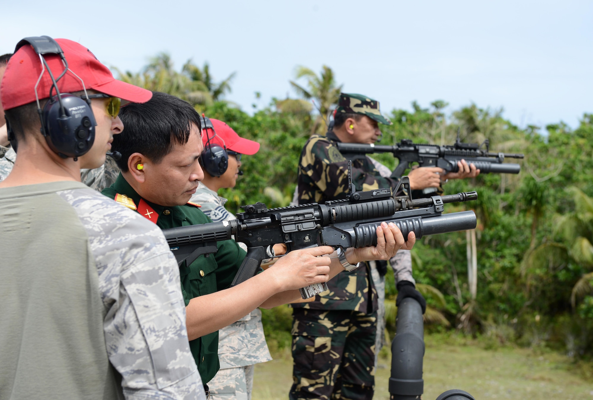 Combat Arms Training Maintenance instructors guide military representatives on shooting procedures during the Pacific Defender Security Forces Subject Matter Expert Exchange 16-1 Feb. 3, 2016, at Andersen Air Force Base, Guam. Pacific Defender 16-1 is an international subject matter expert exchange that helps build partnerships across the Indo-Asia-Pacific region and promotes interoperability. (U.S. Air Force photo/Airman 1st Class Arielle Vasquez)