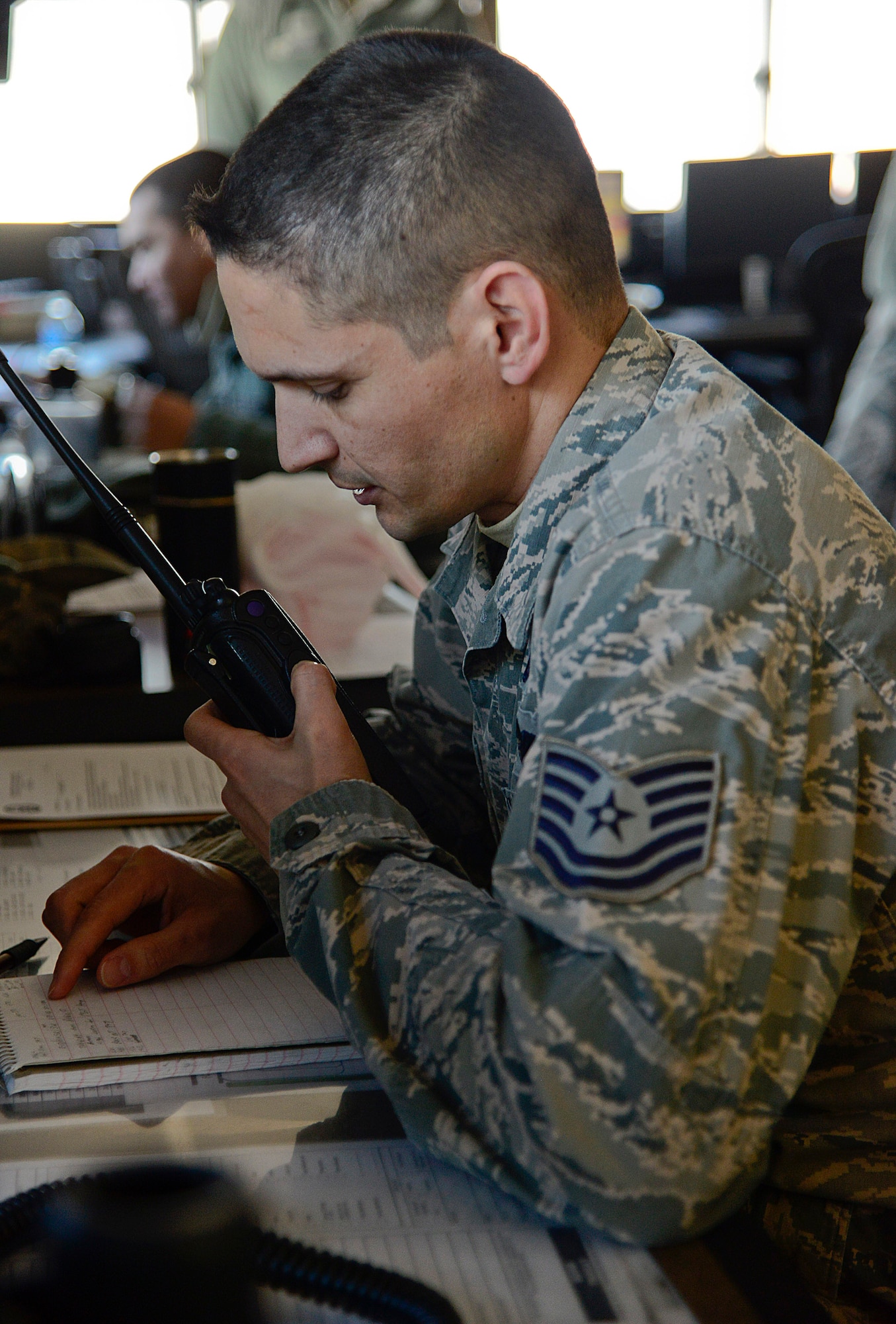 Tech. Sgt. Joaquin Camacho, 731st Air Mobility Squadron Air Terminal Operations Center senior controller, radios information to ground personnel at Osan Air Base, Republic of Korea, Feb. 1, 2016. The ATOC Airmen are responsible for continuously monitoring airlift missions and providing updates to the other sections within the 731st AMS. (U.S. Air Force photo by Senior Airman Kristin High/Released)