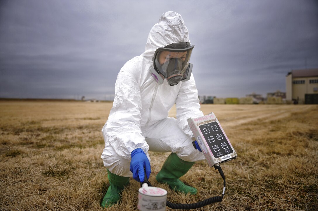 Airman Natalie Gaston, a 374th Medical Support Squadron bioenvironmental technician, simulates using an ADM 300, an instrument that measures radiation in the air, at Yokota Air Base, Japan, Feb. 1, 2016. Bioenvironmental engineering first responders use an ADM 300 to protect them from possible contamination while taking samples. (U.S. Air Force photo/Airman 1st Class Delano Scott)