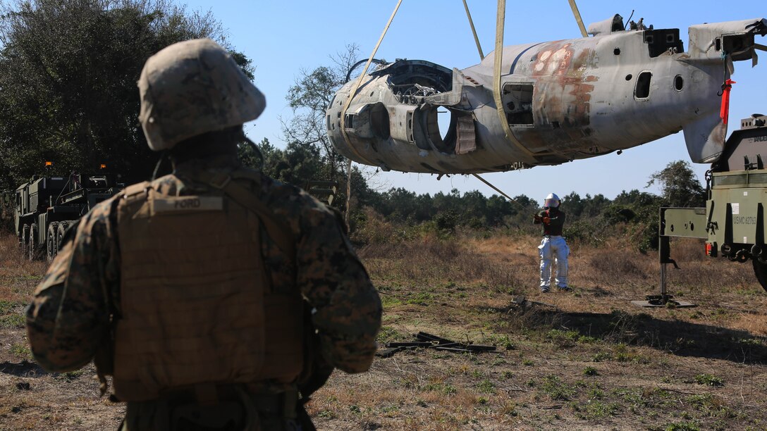 Staff Sgt. William Ford supervises an aircraft suspension during an aircraft recovery training exercise at Marine Corps Auxiliary Landing Field Bogue, N.C., Feb. 2, 2016. Aircraft rescue and firefighting Marines, heavy equipment operators, bulk fuels specialists, motor transportation Marines and combat engineers with Marine Wing Support Squadron 274 worked hand-in-hand to retrieve a simulated downed aircraft. They were given a scenario and were tasked to provide a security perimeter around the aircraft while securing and transporting the aircraft in a safe and effective manner. The ability to retrieve aircraft without the aid of outside resources increases the unit’s effectiveness and their expeditionary capabilities. Ford is the motor transportation operations chieff with MWSS-274. 