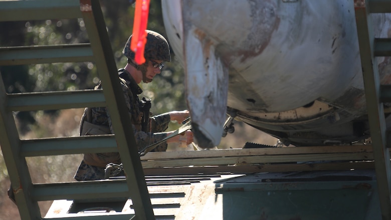 Cpl. Cody Waychoff secures an aircraft during an aircraft recovery training exercise at Marine Corps Auxiliary Landing Field Bogue, N.C., Feb. 2, 2016. Aircraft rescue and firefighting Marines, heavy equipment operators, bulk fuels specialists, motor transportation Marines and combat engineers with Marine Wing Support Squadron 274 worked hand-in-hand to retrieve a simulated downed aircraft. They were given a scenario and were tasked to provide a security perimeter around the aircraft while securing and transporting the aircraft in a safe and effective manner. The ability to retrieve aircraft without the aid of outside resources increases the unit’s effectiveness and their expeditionary capabilities. Waychoff is a motor vehicle operator with MWSS-274. 