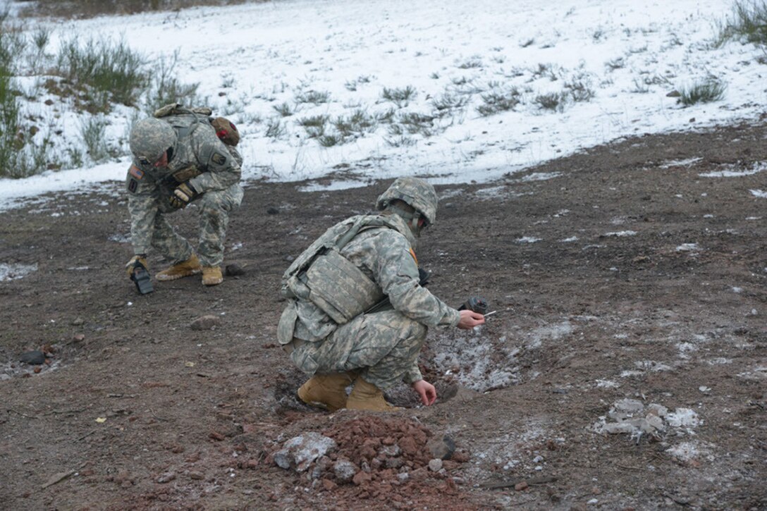 Soldiers measure an exact distance before emplacing charges while participating in basic and advanced explosive ordnance training at Baumholder Military Training Area, Germany, Jan. 21, 2016. Army photo by Erich Backes