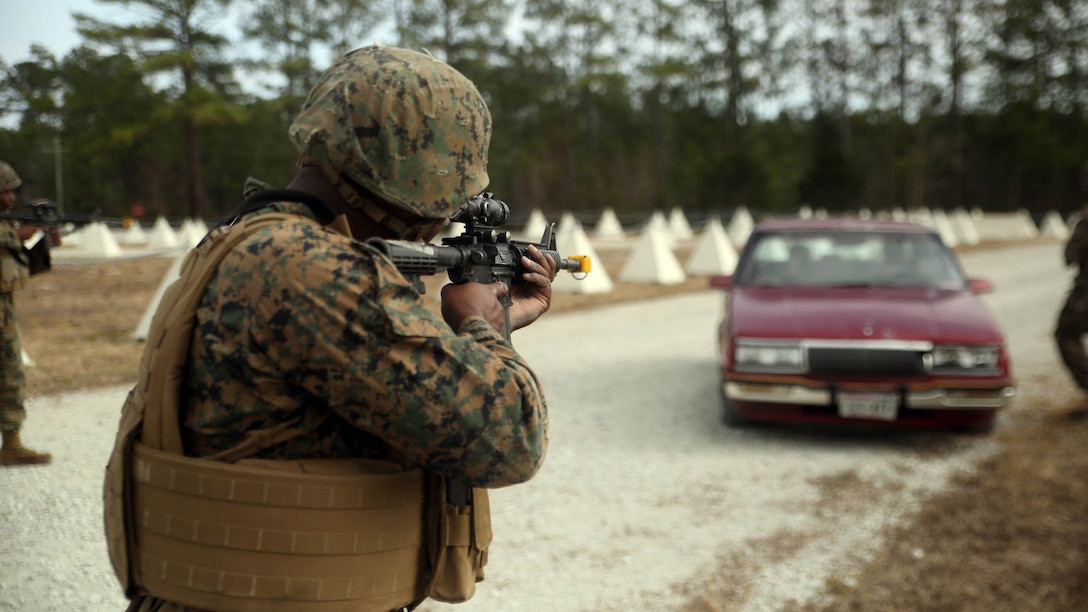 Marines with 2nd Transportation Support Battalion stop a vehicle as it enters the simulated Forward Operating Base Greater Sandy Runs Area during a tactical operations package with Battle Skills Training School, 2nd Marine Logistics Group, at Marine Corps Base Camp Lejeune, N.C., Feb. 3, 2016. The course is conducted to refresh Marines from non-infantry military occupational specialties on infantry-related skills and tactics in a five-week span. 