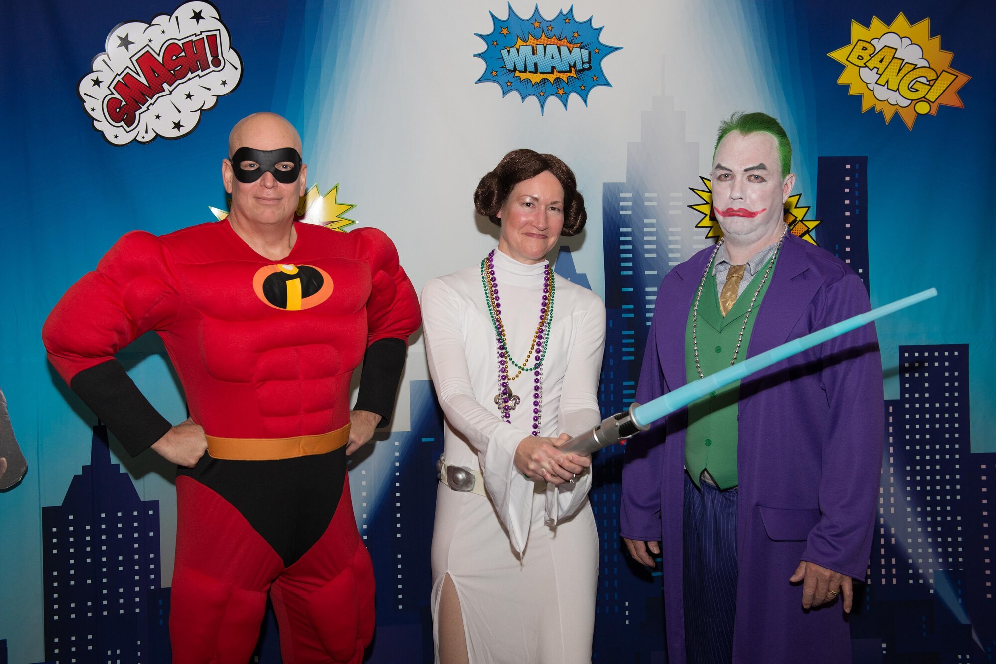 Col. Thomas Harrell, 81st Medical Group commander, Col. Susan Airola-Skully, 81st Mission Support Group commander, and Col. Scott Solomon, 81st Training Group commander, take a photo at the 28th Annual Krewe of Medics Mardi Gras Ball at the Bay Breeze Event Center Jan. 30, 2016, Keesler Air Force Base, Miss. The Krewe of Medics hosts a yearly ball to give military personnel assigned to the Keesler Medical Center a taste of the Gulf Coast and an opportunity to experience a traditional Mardi Gras. The theme for this year's ball was superheroes and villains. (U.S. Air Force photo by Marie Floyd)