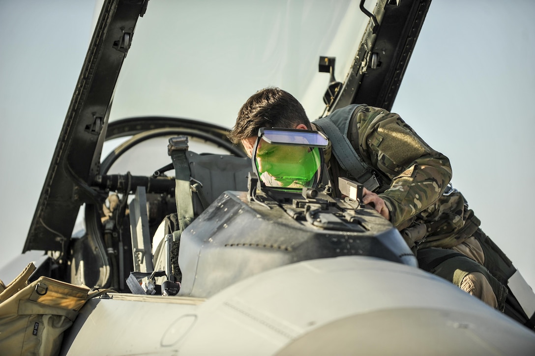 Air Force Lt. Col. Thomas Wolfe performs preflight checks inside his F-16 Fighting Falcon aircraft on Bagram Airfield, Afghanistan, Feb. 1, 2016. Air Force photo by Tech. Sgt. Nicholas Rau 