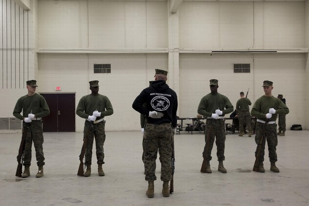 Lance Cpl. Jarris Wade, a Silent Drill School instructor, conducts baseline drill sequence training, called landing party manual, with students at Joint Base Anacostia, Washington, D.C., Jan. 8, 2016. Each year from November to March the Silent Drill Platoon conducts Silent Drill School to hand-select new Marines for the upcoming parade season.  The selection process is conducted by Marines from previous years to identify Marines who will represent, on the parade deck, the professionalism associated with the Marine Corps. (Official Marine Corps photos by Cpl. Chi Nguyen/Released)