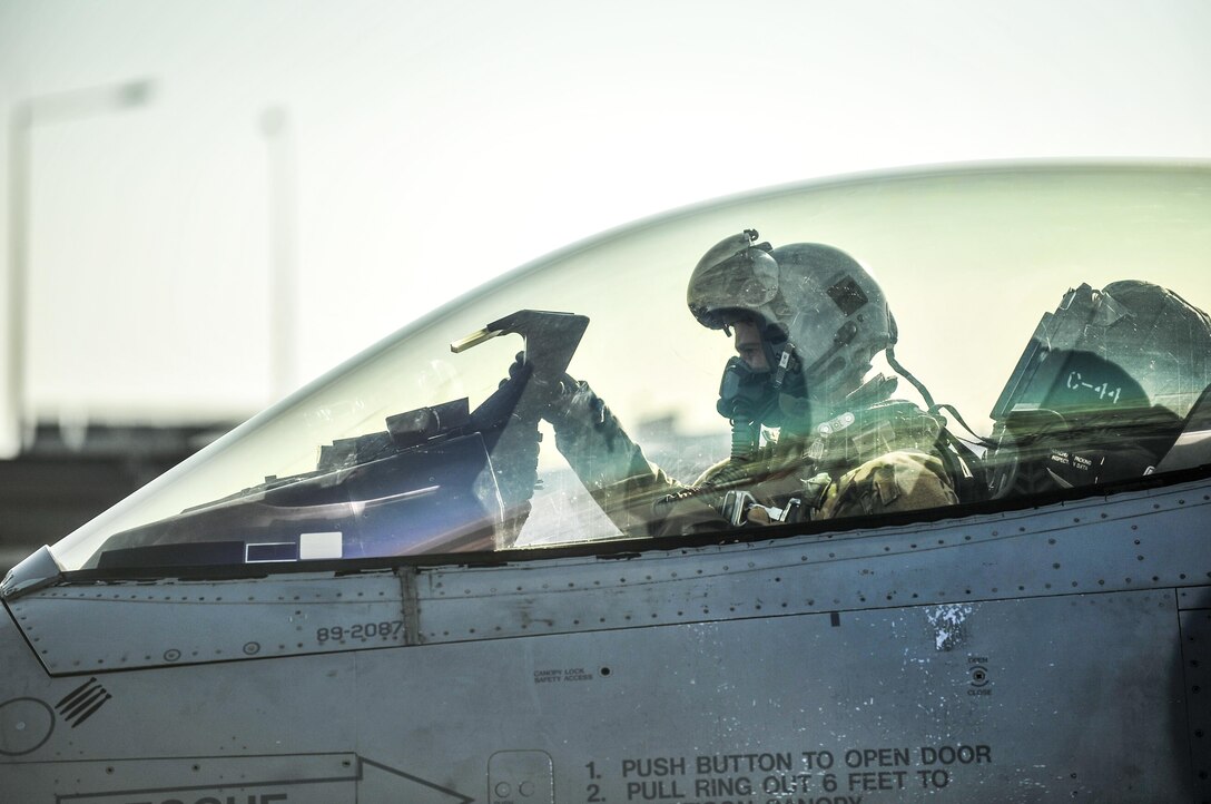 Air Force Lt. Col. Thomas Wolfe, deputy commander of the 455th Expeditionary Operations Group, performs preflight checks on an F-16 Fighting Falcon at Bagram Airfield, Afghanistan, Feb. 1, 2016. 