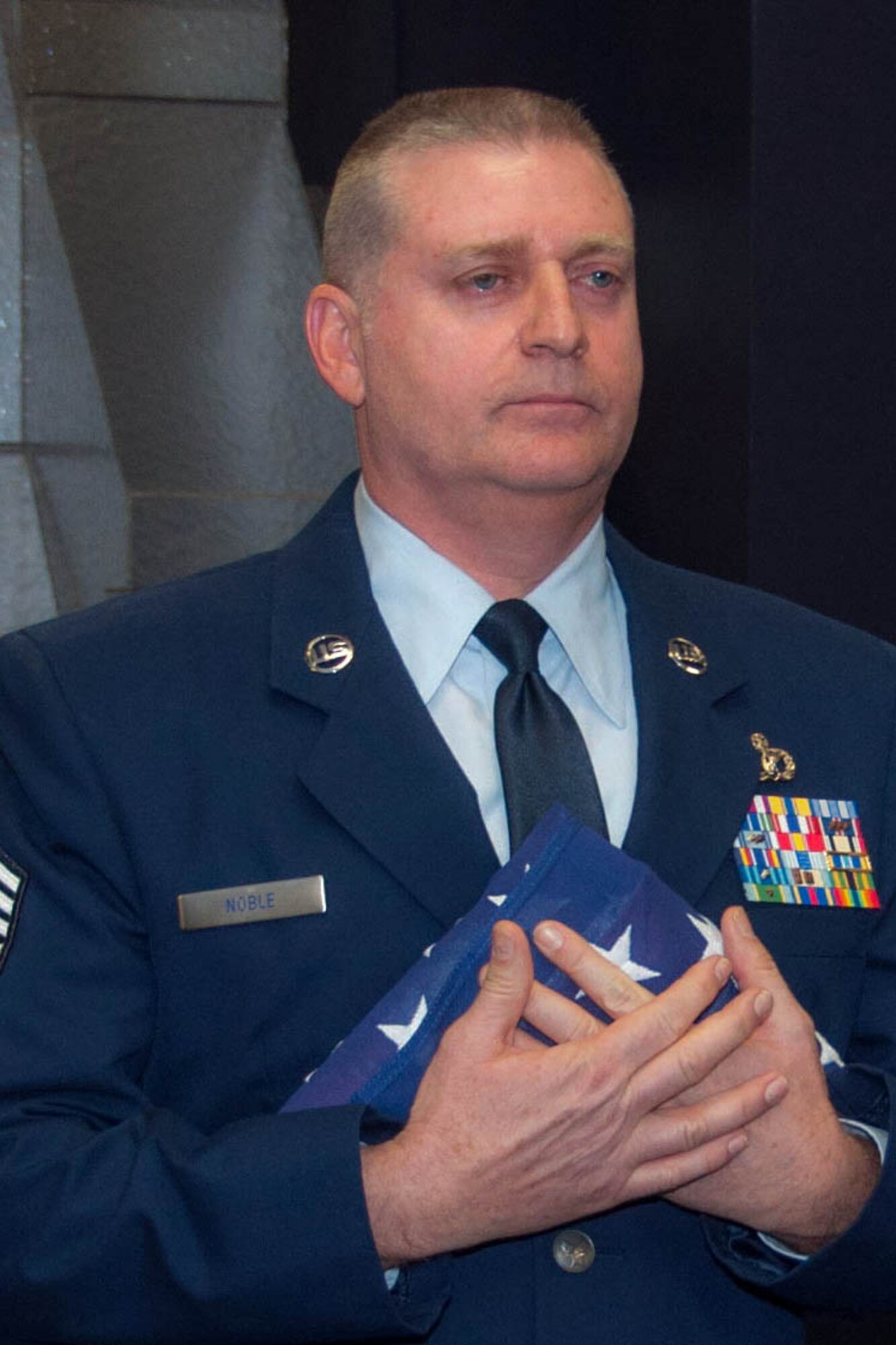 U.S. Air Force Chief Master Sgt. Randall Noble, the 307th Bomb Wing’s command chief master sergeant, accepts a flag during his retirement ceremony at Barksdale Air Force Base, La., Jan. 30, 2016.  A large gathering of family and friends attended the ceremony to wish Noble well during his retirement ceremony.  (U.S. Air Force photo by Master Sgt. Laura Siebert /Released)