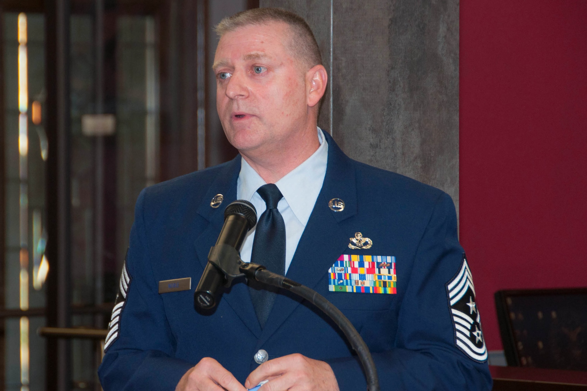 U.S. Air Force Chief Master Sgt. Randall Noble, the 307th Bomb Wing command chief master sergeant, addresses a gathering of family and friends at his retirement ceremony at Barksdale Air Force Base, La., Jan. 30, 2016. Chief Noble thanked his family for their support over the years. (U.S. Air Force photo by Master Sgt. Laura Siebert /Released)