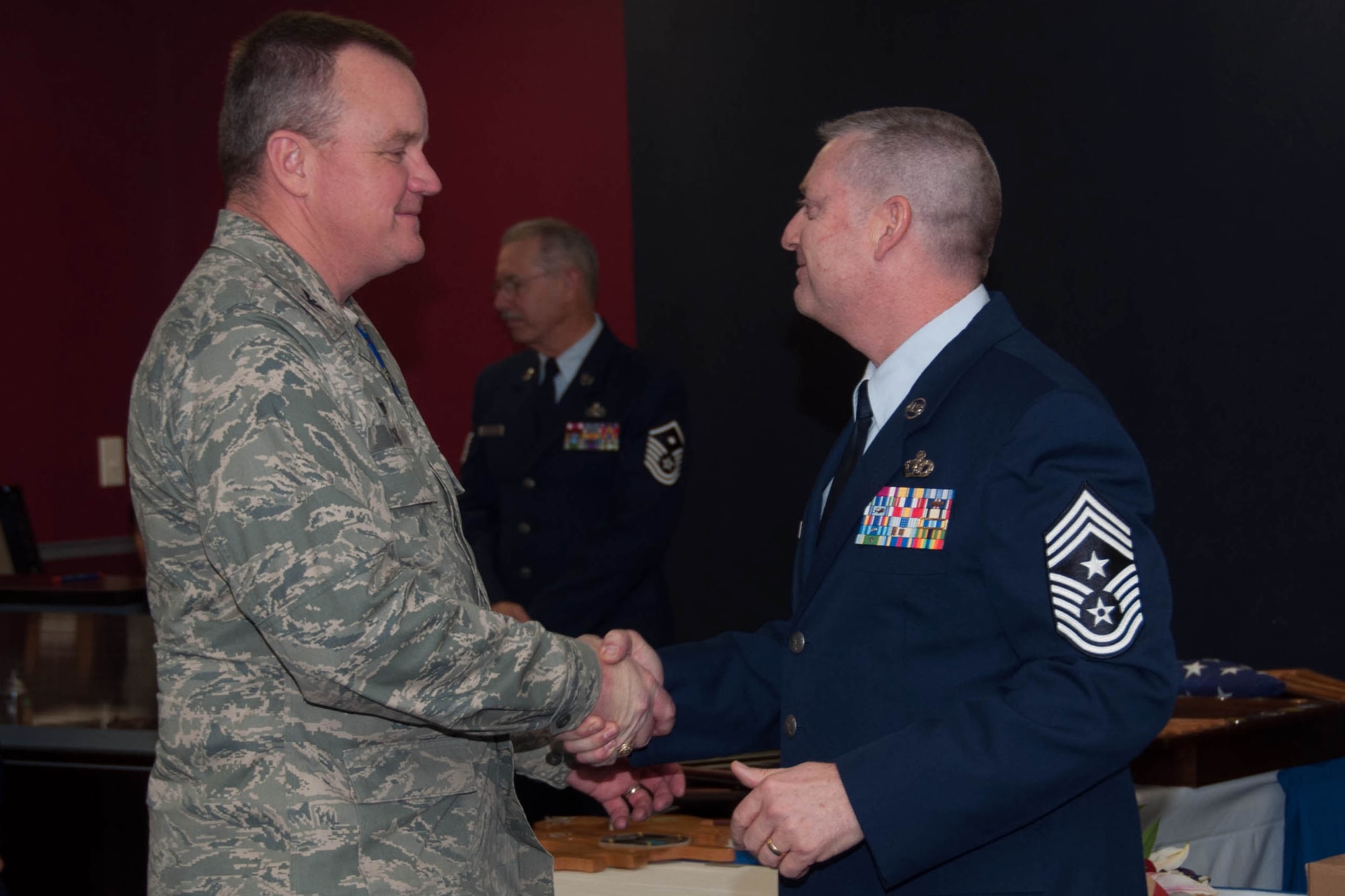 U.S. Air Force Col. Bruce Cox, commander of the 307th Bomb Wing, coins Command Chief Master Sgt. Randall Noble at Noble’s retirement ceremony at Barksdale Air Force Base, La., Jan. 30, 2016. Noble served as the 307th Bomb Wing’s Command Chief Master Sgt. for two and a half years. (U.S. Air Force photo by Master Sgt. Laura Siebert /Released)
