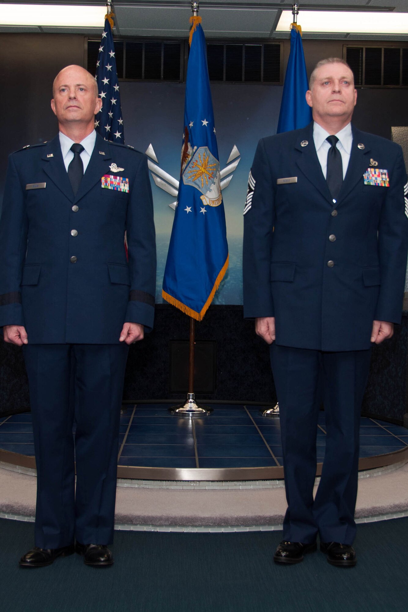 U.S. Air Force Brig. General Jonathan Ellis, mobilization assistant to the Director of Operations, Headquarters Air Force Global Strike Command, and Chief Master Sgt. Randall Noble, the 307th Bomb Wing command chief master sergeant, listen as Noble’s retirement order is read during his retirement ceremony at Barksdale Air Force Base, La., Jan. 30, 2016. Noble is retiring after thirty years of service. (U.S. Air Force photo by Master Sgt. Laura Siebert /Released)