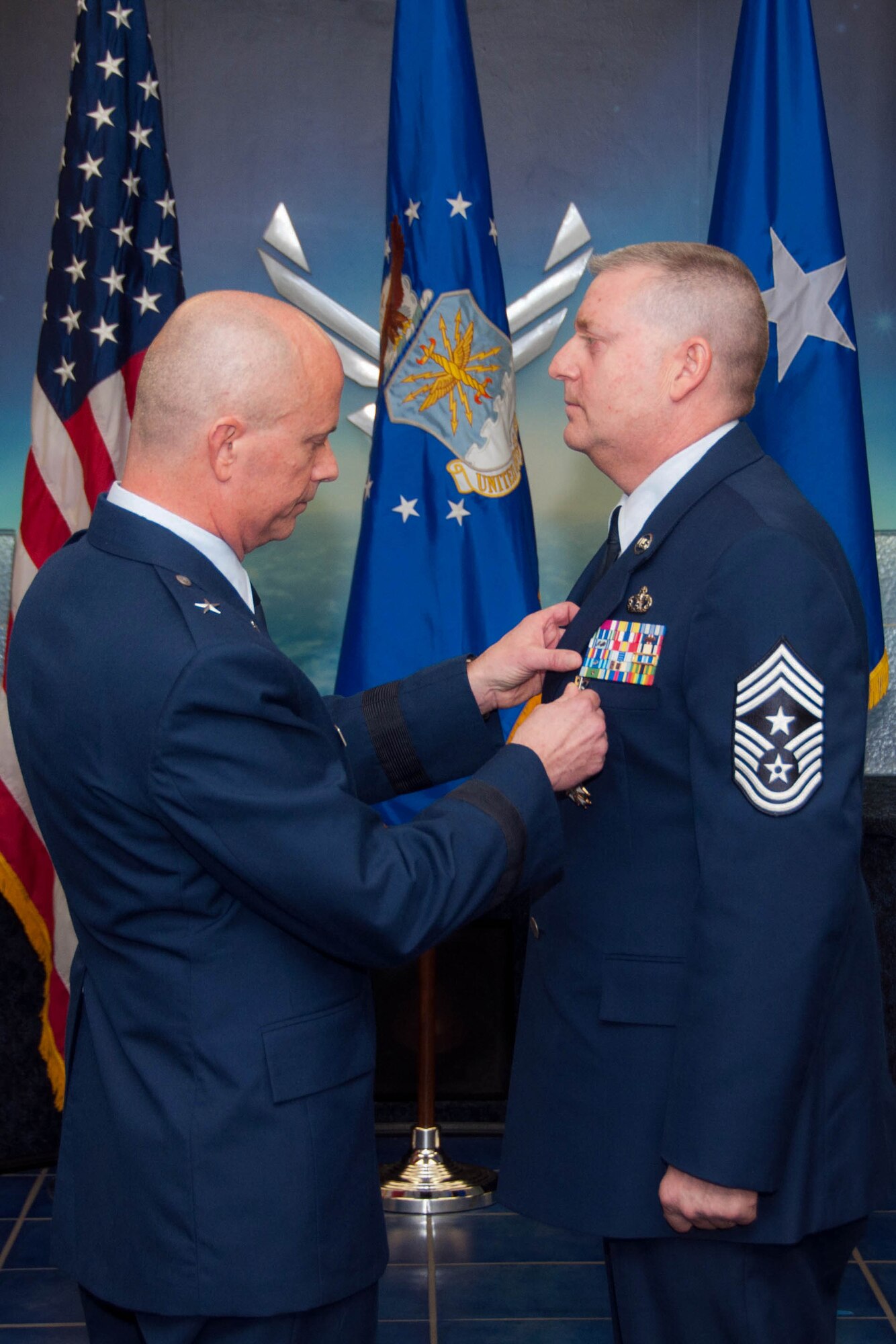 U.S. Air Force Brig. General Jonathan Ellis, mobilization assistant to the Director of Operations, Headquarters Air Force Global Strike Command, pins a Legion of Merit Medal on Command Chief Master Sgt. Randall Noble at Noble’s retirement ceremony at Barksdale Air Force Base, La., Jan. 30, 2016. Chief Noble is retiring from the 307th Bomb Wing after over thirty years of service. (U.S. Air Force photo by Master Sgt. Laura Siebert /Released)