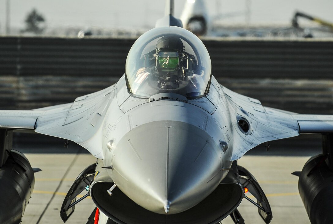 Air Force Lt. Col. Thomas Wolfe performs preflight checks on an F-16 Fighting Falcon aircraft on Bagram Airfield, Afghanistan, Feb. 1, 2016. Wolfe is deputy commander of the 455th Expeditionary Operations Group. Air Force photo by Tech. Sgt. Nicholas Rau