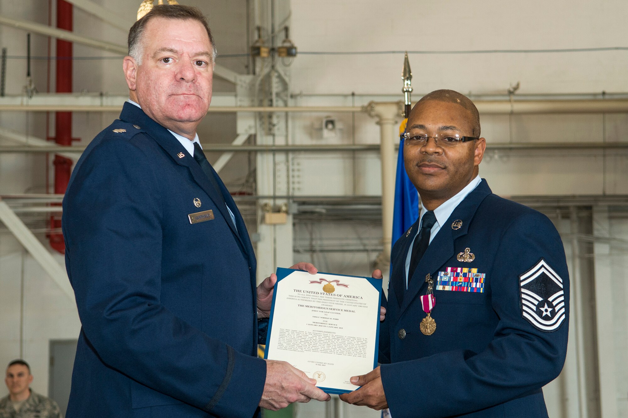 U.S. Air Force Lt. Col. Leo Kamphaus, 307th Maintenance Group commander, presents the Meritorious Service Medal to Senior Master Sgt. Norman Ford during a Commander’s Call on Jan. 31, 2016, Barksdale Air Force Base, La. Ford received the award for outstanding service to the United States while assigned to the 307th Maintenance Squadron from Jan. 1, 2010 to Jan. 1, 2015. (U.S. Air Force photo by Master Sgt. Greg Steele/Released)