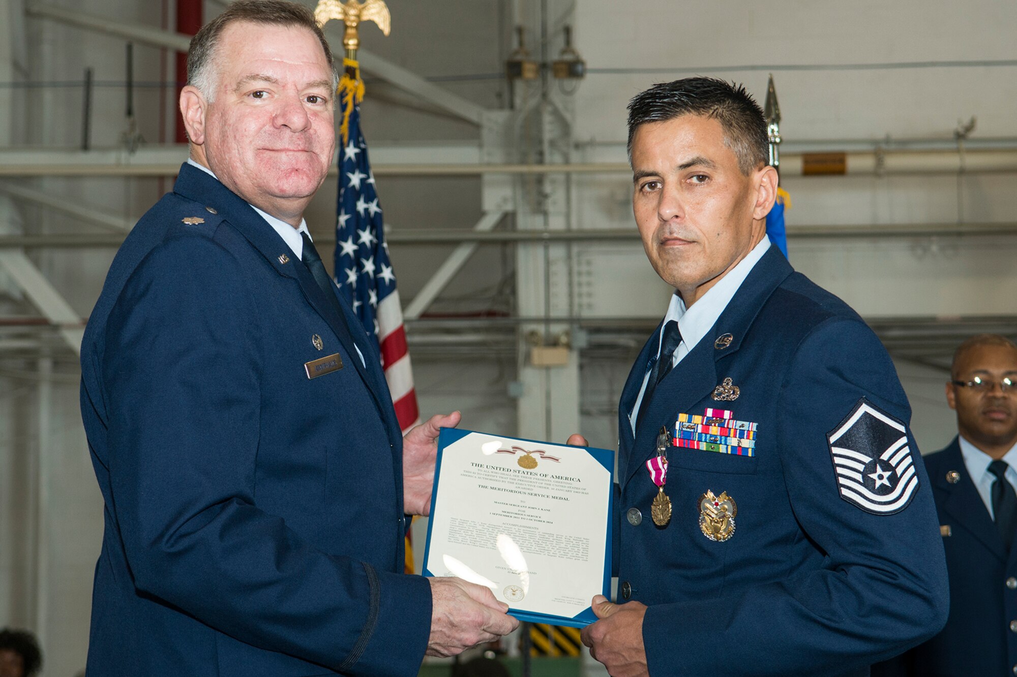 U.S. Air Force Lt. Col. Leo Kamphaus, 307th Maintenance Group commander, presents the Meritorious Service Medal to Master Sgt. John Kane during a Commander’s Call on Jan. 31, 2016, Barksdale Air Force Base, La. Kane received the award for outstanding service to the United States while assigned to the 307th Maintenance Squadron from Sept. 1, 2011 to Oct. 1, 2014. (U.S. Air Force photo by Master Sgt. Greg Steele/Released)