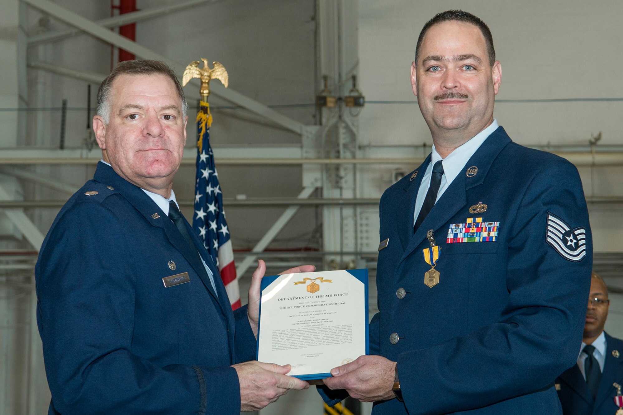 U.S. Air Force Lt. Col. Leo Kamphaus, 307th Maintenance Group commander, presents the Air Force Commendation Medal to Tech. Sgt. Anthony Johnson during a Commander’s Call on Jan. 31, 2016, Barksdale Air Force Base, La. Johnson received the award for outstanding achievement while assigned to the 307th Maintenance Squadron from Sept. 3, 2011 to Dec. 31, 2013. (U.S. Air Force photo by Master Sgt. Greg Steele/Released)