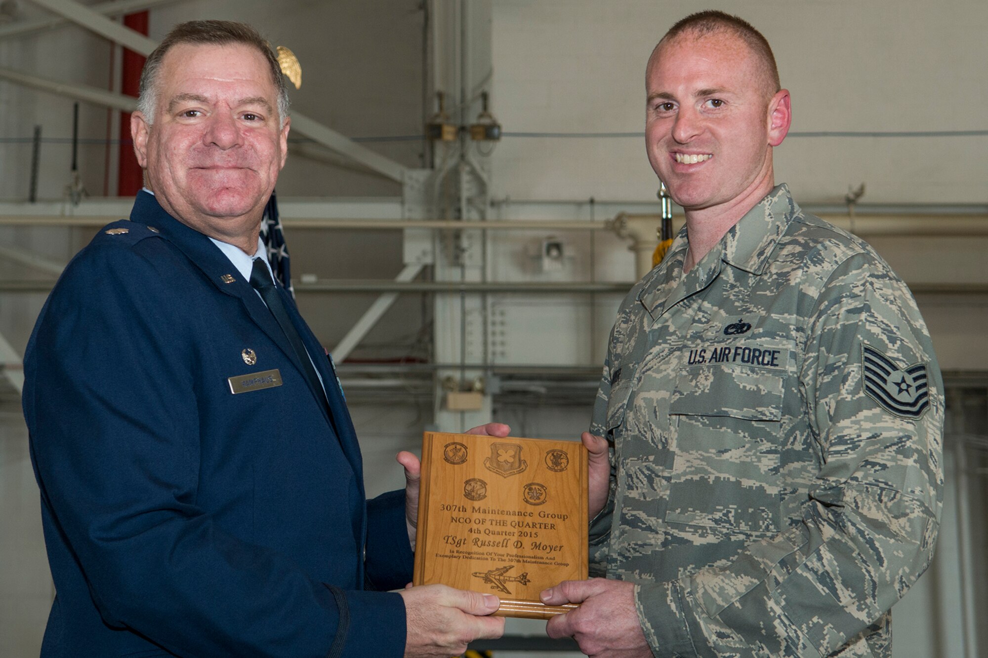 U.S. Air Force Lt. Col. Leo Kamphaus, 307th Maintenance Group commander, presents an award to Tech. Sgt. Russell Moyer during a Commander’s Call on Jan. 31, 2016, Barksdale Air Force Base, La. Moyer was selected as the 307th Maintenance Squadron Non-Commissioned Officer of the Quarter for the period covering October to December 2015. (U.S. Air Force photo by Master Sgt. Greg Steele/Released)
