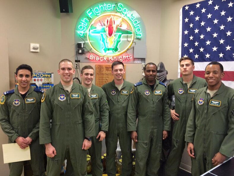 The newest graduates of Introduction to Fighter Fundamentals pause for a photo Feb. 1 in the 49th Fighter Squadron on Columbus Air Force Base, Mississippi. The nine-week course begins with tactical formation flights and then introduces pilots and weapon system operators to basic fighter maneuvers and air-to-air employment in offensive, defensive, and high aspect fight scenarios.  (Courtesy photo/Col. John Nichols)