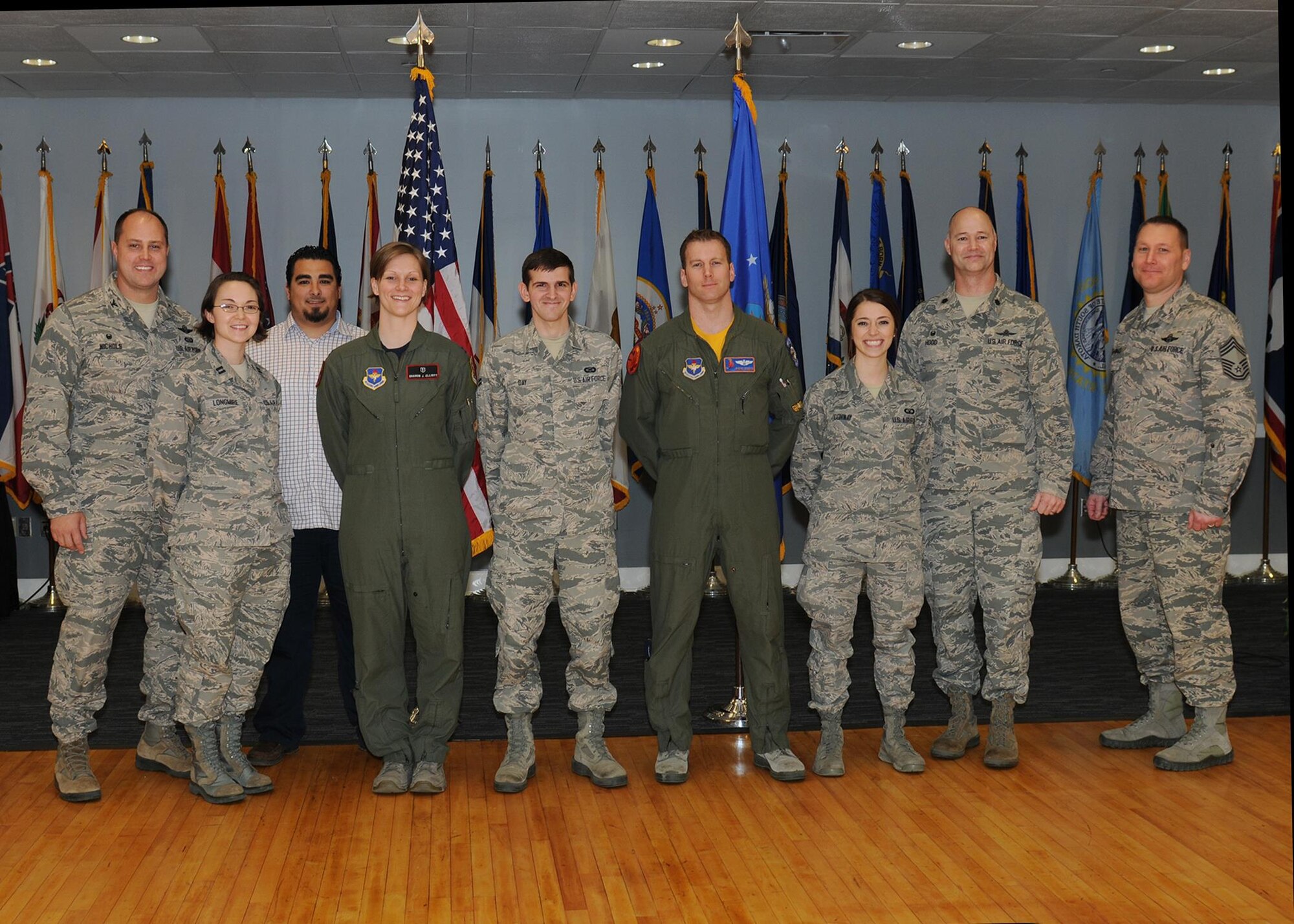 The fourth quarterly awards winners or their representatives pause for a photo on stage Jan. 29 at the Columbus Club at Columbus Air Force Base, Mississippi. The ceremony honored the wing’s outstanding professionals for the months of October through December whose drive, determination and dedication have earned them this recognition. (U.S. Air Force photo/Melissa Doublin)