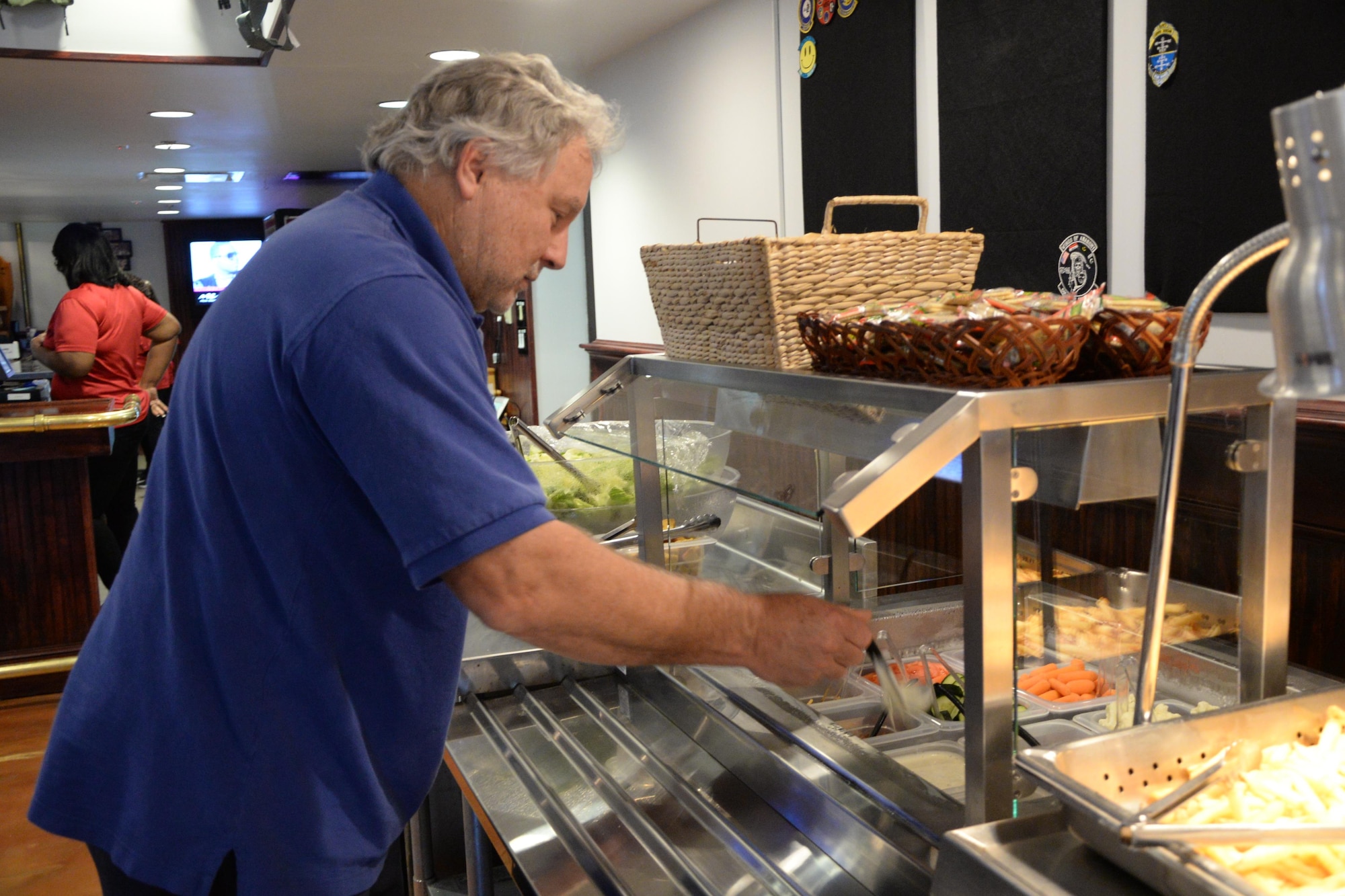 David Tedford, Hunt Housing technician, grabs a plate of the “Chef’s Special” Feb. 1 on the reopening day of the Columbus Club on Columbus Air Force Base, Mississippi. The Columbus Club has been undergoing renovations for the past nine months. (U.S. Air Force photo/2nd Lt. Lauren Woods) 