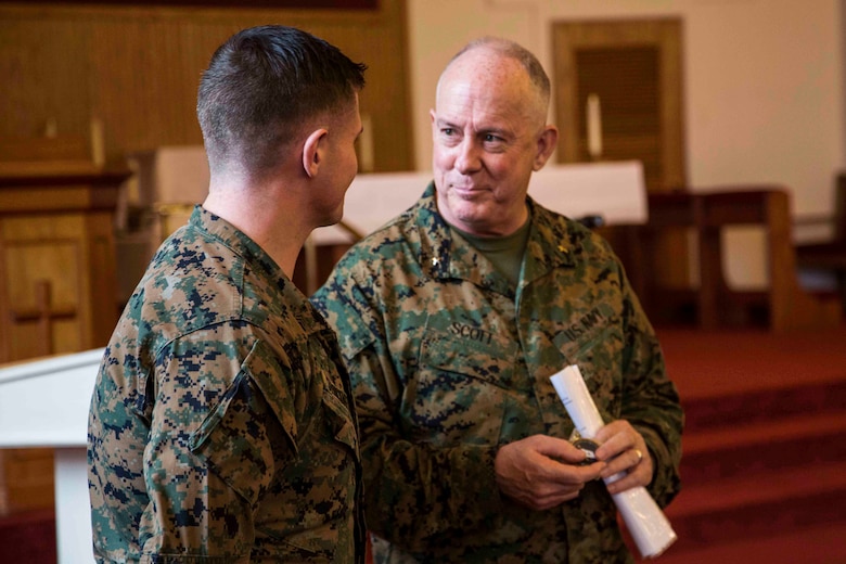 Rear Admiral Brent W. Scott speaks to a Marine in the chapel aboard Marine Corps Air Station Beaufort Feb. 3. Chaplains are religious and spiritual leaders who speak to their Marines on a personal level. Scott gave time for Marines to ask him direct questions at the end of each talk he gave. This allowed them to relate to him directly and bring up topics they were interested in. Scott is the 19th Chaplain of the United States Marine Corps and the Deputy Chief of Navy Chaplains. The Marine is with Marine Aircraft Group 31.