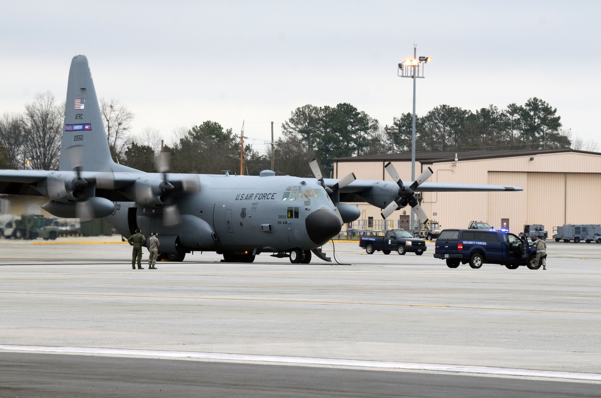 Members of the 94th Security Forces Squadron position themselves around a C-130 Hercules during a mock anti-hijacking exercise conducted on Dobbins Air Reserve Base, Ga. Feb. 1, 2016. The scenario, a disgruntled aircrew member attempted to hijack the aircraft and its crew, from the 700th Airlift Squadron and 94th Aeromedical Evacuation Squadron. An unauthorized engine start alerted maintenance and air traffic control tower personnel of the attempt. Security forces responded and apprehended the alleged hijacker. (U.S. Air Force photo/Don Peek)