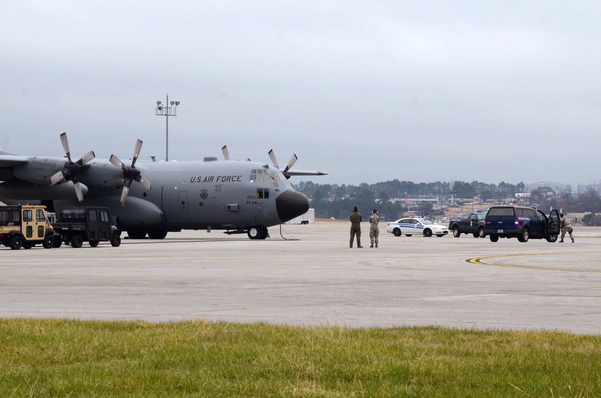 Members of the 94th Security Forces Squadron position themselves around a C-130 Hercules during a mock anti-hijacking exercise conducted on Dobbins Air Reserve Base, Ga. Feb. 1, 2016. The scenario, a disgruntled aircrew member attempted to hijack the aircraft and its crew, from the 700th Airlift Squadron and 94th Aeromedical Evacuation Squadron. An unauthorized engine start alerted maintenance and air traffic control tower personnel of the attempt. Security forces responded and apprehended the alleged hijacker. (U.S. Air Force photo/Don Peek)
