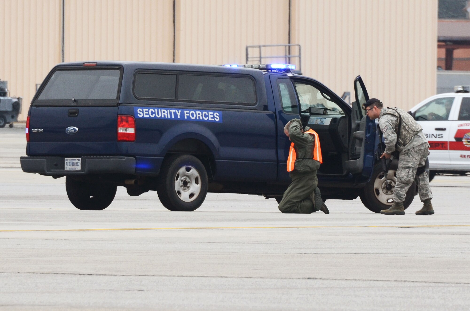 Staff Sgt. William Burke,94th Security Forces Squadron, apprehends an alleged hijacker during a mock anti-hijacking exercise conducted on Dobbins Air Reserve Base, Ga. Feb. 1, 2016. The scenario, a disgruntled aircrew member attempted to hijack a C-130 Hercules and its crew, from the 700th Airlift Squadron and 94th Aeromedical Evacuation Squadron. An unauthorized engine start alerted maintenance and air traffic control tower personnel of the attempt. (U.S. Air Force photo/Don Peek)