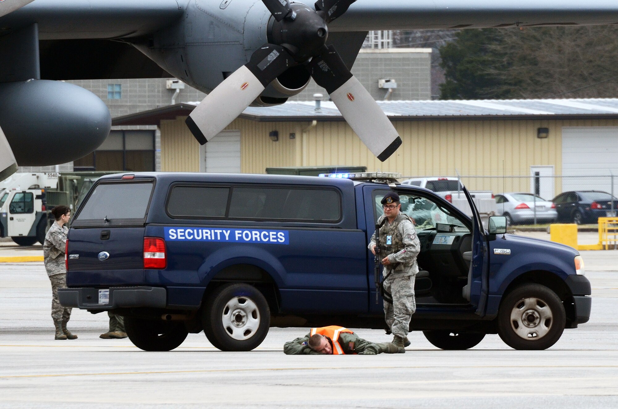 Staff Sgt. William Burke from the 94th Security Forces Squadron apprehends an alleged hijacker during a mock anti-hijacking exercise conducted on Dobbins Air Reserve Base, Ga. Feb. 1, 2016. The scenario, a disgruntled aircrew member attempted to hijack a C-130 Hercules and its crew, from the 700th Airlift Squadron and 94th Aeromedical Evacuation Squadron. An unauthorized engine start alerted maintenance and air traffic control tower personnel of the attempt. (U.S. Air Force photo/Don Peek)