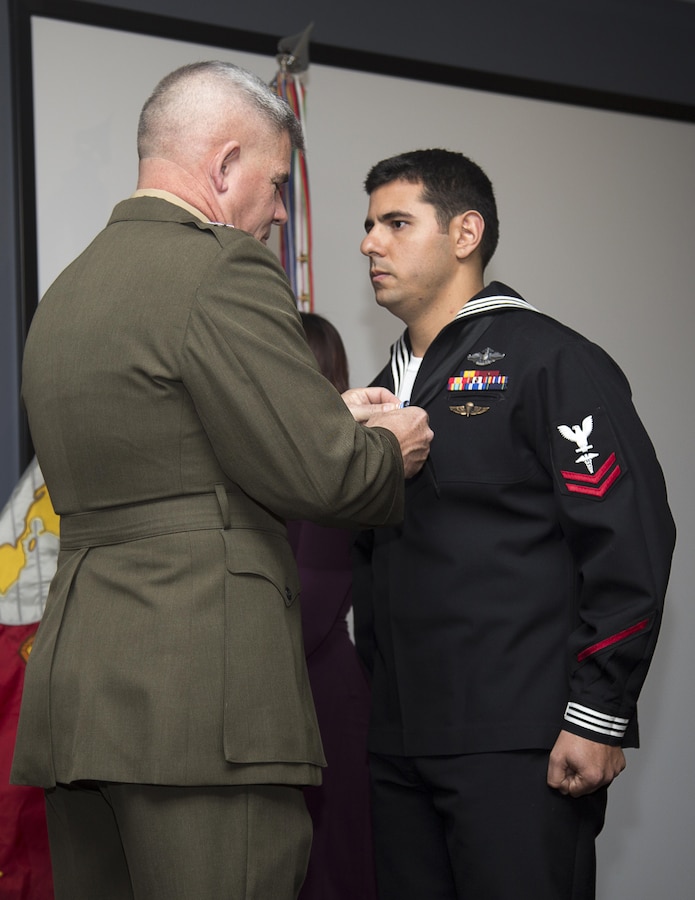 Major Gen. Joseph L. Osterman, commander, U.S. Marine Corps Forces, Special Operations Command, presents Petty Officer 2nd Class Alejandro Salabarria, a corpsman with Marine Special Operations Company F, 2nd Marine Raider Battalion, the Silver Star Medal during a ceremony at Stone Bay aboard Marine Corps Base Camp Lejeune, N.C., Feb. 5, 2016. Salabarria was awarded for his actions in Afghanistan Sept.15, 2014.