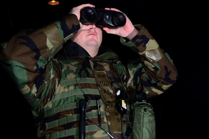 U.S. Air Force Tech. Sgt. Alan Douglas, 8th Operations Support Squadron air traffic control watch supervisor, scans the run-way during jet take-offs for Beverly Pack 16-2 at Kunsan Air Base, Republic of Korea, Feb. 04, 2016. The air traffic control tower oversees the base's entire flight line and its height allows air traffic controllers to see aircraft flying within the base's immediate air space. (U.S. Air Force photo by Senior Airman Ashley L. Gardner/Released)