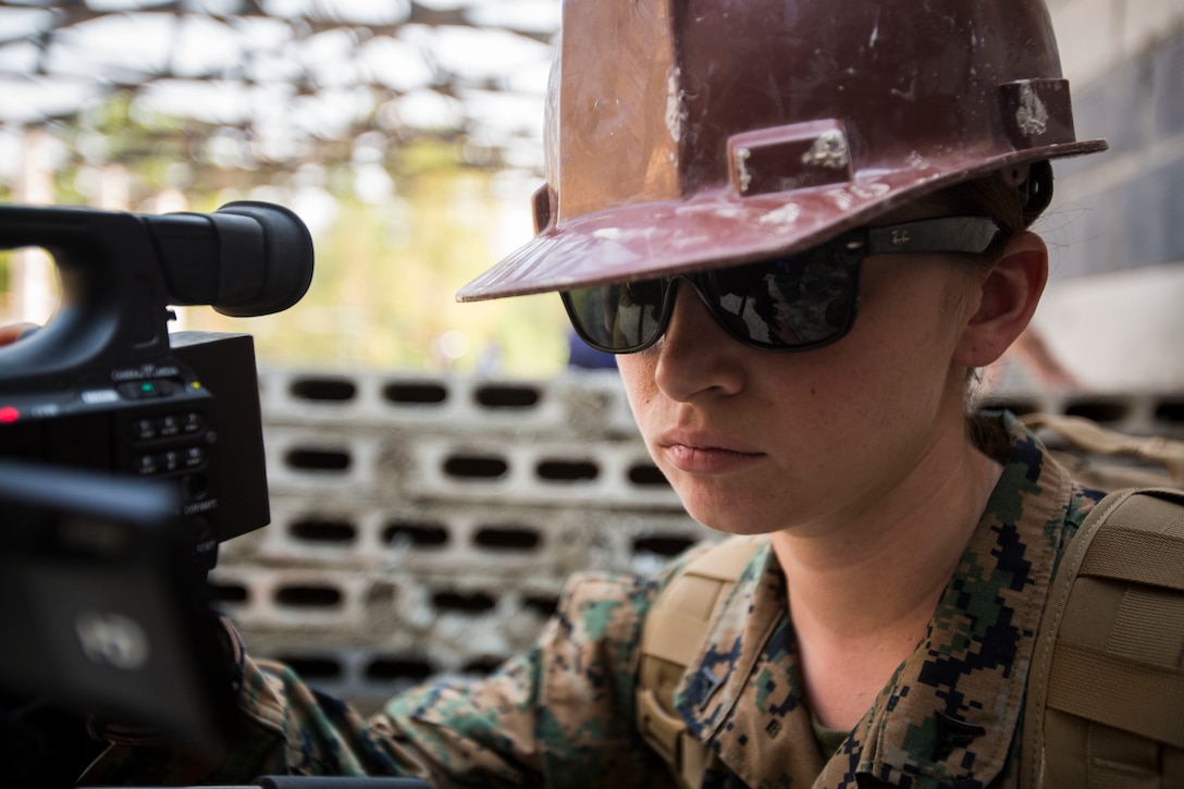 U.S. Marine Corps Lance Cpl. Megan Boulrice, combat videographer with U.S. Marine Corps Forces Pacific, documents the construction of a multi-purpose room at Ban Cham Kho School, in Rayong, Thailand, during exercise Cobra Gold, Feb. 4, 2016.  Cobra Gold 2016, in its 35th iteration, includes a specific focus on humanitarian civic action, community engagement, and medical activities conducted during the exercise to support the needs and humanitarian interests of civilian populations around the region. 