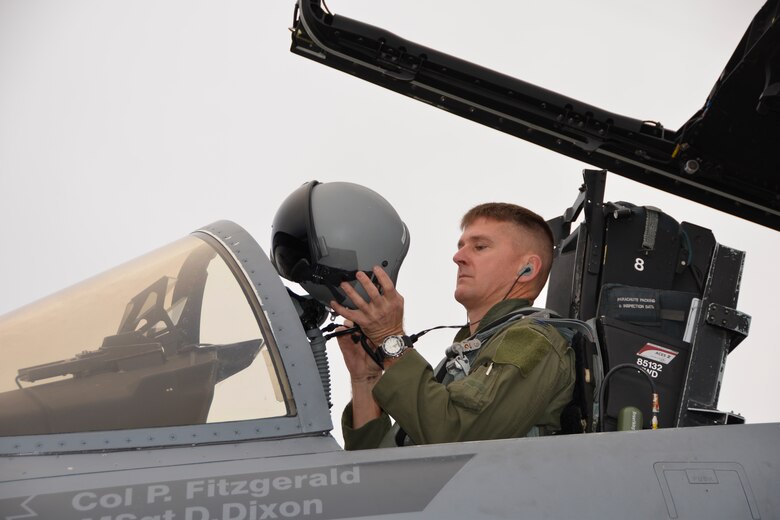 Col. Derek Routt, 1st Air Force (Air Forces Northern) Deputy Chief of Staff, checks his helmet prior to a flight during Combat Archer at Tyndall Air Force Base Jan. 28. Combat Archer is a two-week weapon systems evaluation program where participants load, fly and shoot live missiles and subsequently evaluate the entire process to validate whether the weapon performs according to established specifications. (Air Force Photo Released/Mary McHale)

