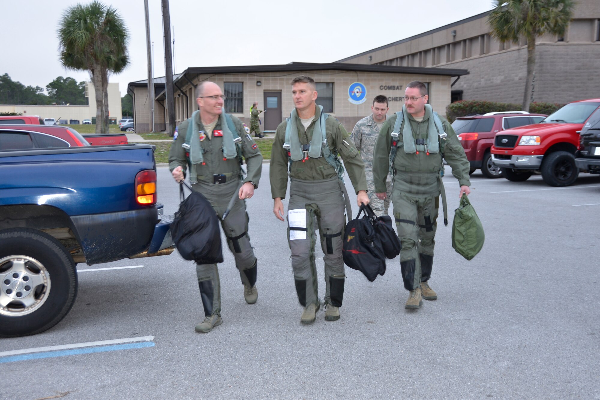 Col. Paul Fitzgerald, 142nd Fighter Wing Commander (left) walks out to the Tyndall Air Force Base flightline with Col. Derek Routt, 1st Air Force (Air Forces Northern) Deputy Chief of Staff and Master Sgt. Tad Benner, 142nd Maintenance Group weapons loader, Jan. 28. Fitzgerald was here with a team from Portland, Oregon’s 142nd Fighter Wing to fly in the 53rd Weapon Evaluation Group’s Combat Archer, a two-week weapon systems evaluation program where participants load, fly and shoot live missiles and subsequently evaluate the entire process to validate whether the weapon performs according to established specifications. Benner was receiving an incentive flight for outstanding duty performance. (Air Force Photo Released/Mary McHale)