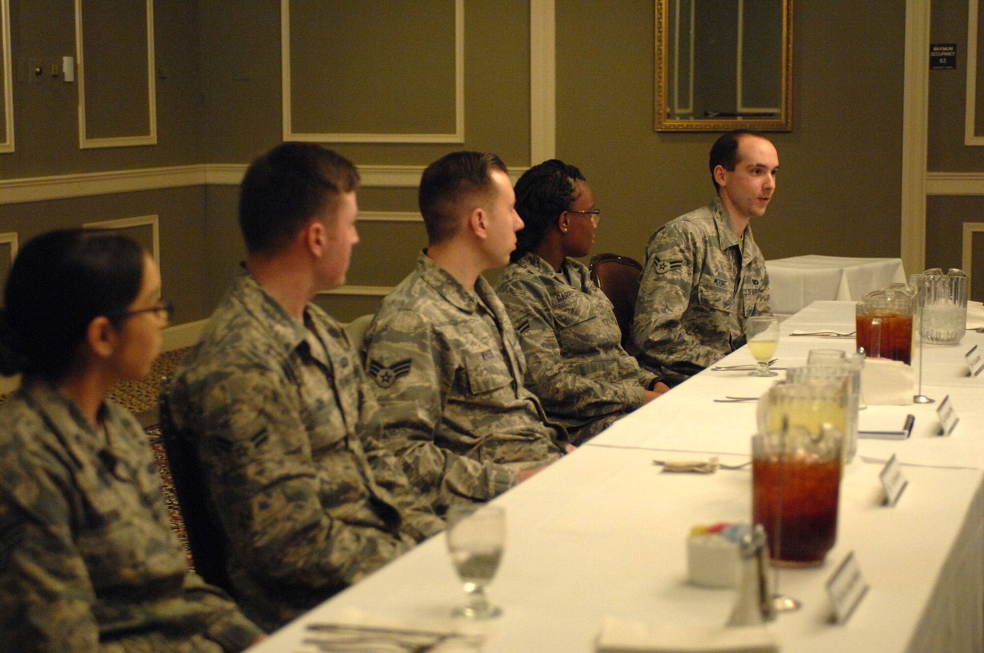 Members of the panel for the Offutt Diversity Team's Voice of the Future Lunch and Learn turn to listen as Airman 1st Class Andrew Moore, 55th Security Forces Squadron, shares his opinion on DUI infractions in the military at the Patriot Club, Jan. 27, 2016. The panel, comprised of Airman from Offutt Air Force Base, Neb., gave senior leaders an opportunity to ask about problems facing the younger generation of Airmen. (U.S. Air Force photo/Senior Airman Rachel Hammes)