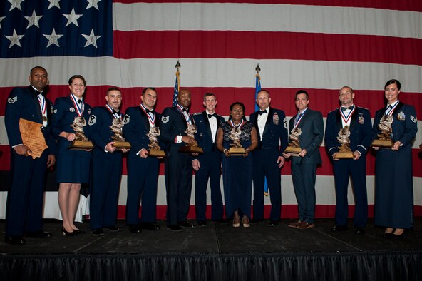 The 2015 Annual Award winners pose for a photo with Moody’s senior leaders during a ceremony, Feb. 4, 2016, at Moody Air Force Base, Ga. Annual awards are given to those that go above and beyond their duty title and strive for self-improvement. (U.S. Air Force photo by Airman 1st Class Lauren M. Johnson/Released)