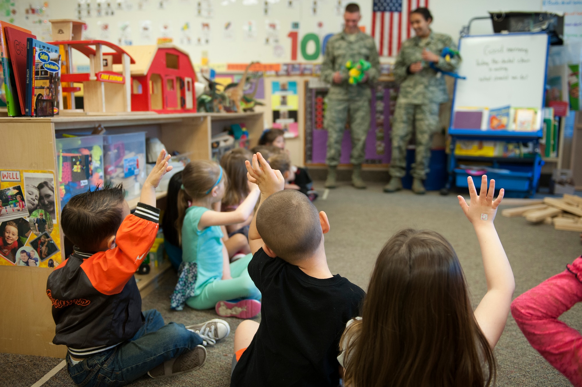 Children from the Child Development Center raise their hands during National Children’s Dental Health Month, Feb. 2, 2016, at Moody Air Force Base, Ga. A dentist and dental assistant from the 23d Aerospace Medical Squadron spoke with the children about the importance of dental hygiene. (U.S. Air Force photo by Airman 1st Class Kathleen D. Bryant/Released)
