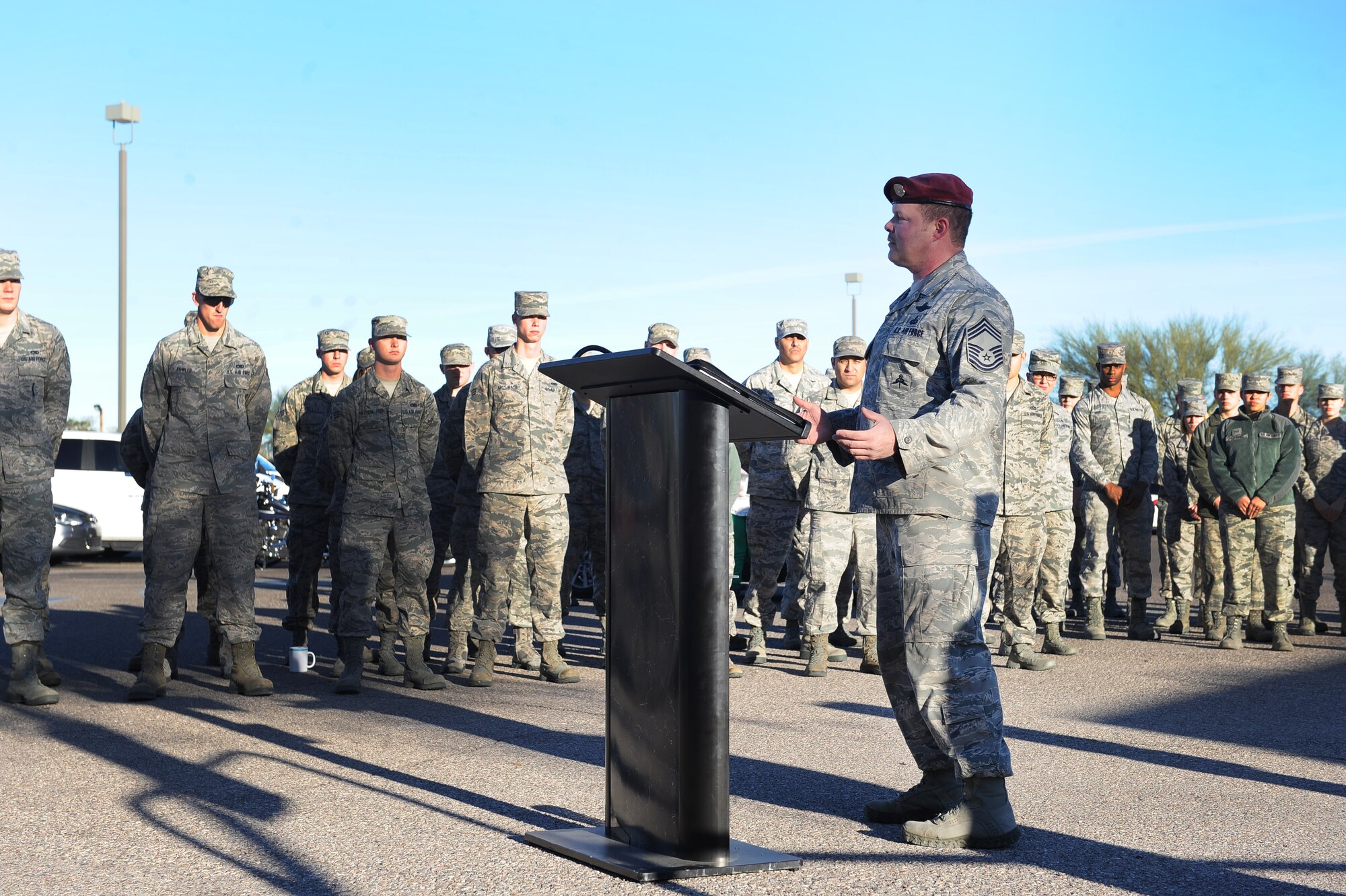 U.S. Air Force Chief Master Sgt. Robert Disney, 48th Rescue Squadron superintendent, delivers a speech at the Purple Heart recipient parking space dedication event in the Exchange parking lot at Davis-Monthan Air Force Base, Ariz., Feb. 4, 2016. Disney is one of six active duty members on base who have received the Purple Heart medal. (U.S. Air Force photo by Senior Airman Cheyenne A. Powers/Released)