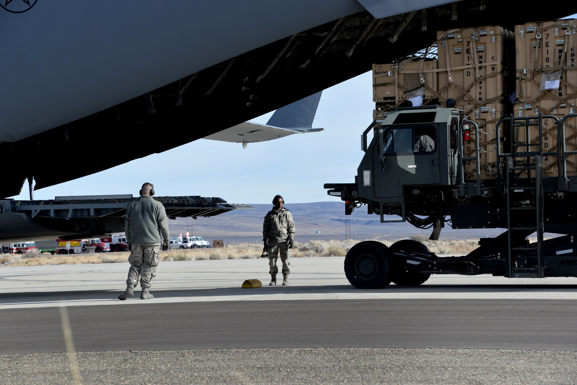 Airmen from the 821st CRW load cargo onto a C-17 Globemaster III Jan. 21 during a unit exercise at Amedee. The three-day exercise focused on the goup's primary mission-set of opening an air base in an austere location. (U.S. Air Force photo by Staff Sgt. Charles Rivezzo) 