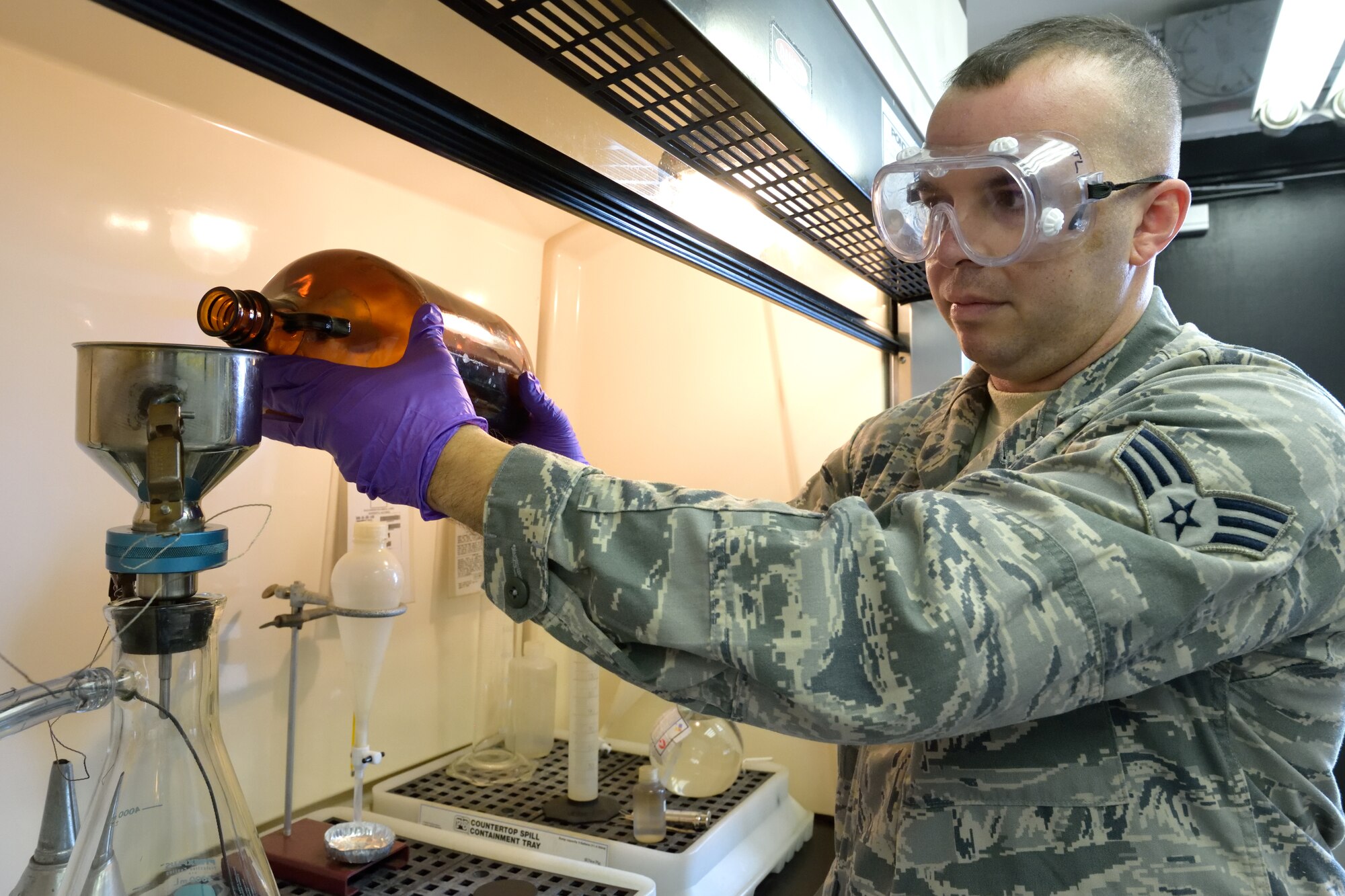 Senior Airman John Ortiz-Morales, 403rd Logistics Readiness Squadron fuels quality control specialist, performs the particles contamination test, or bottle method, to determine if there is any sediment in the Jet A fuel sample Jan. 9, 2016, at Keesler Air Force Base, Mississippi. Fuels quality control specialists are responsible for making sure the fuel used by U.S. Air Force aircraft is fit for flight. (U.S. Air Force photo/Tech. Sgt. Ryan Labadens)