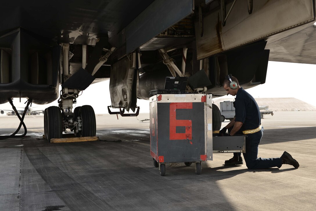 Airman 1st Class Brian, 28th Aircraft Maintenance Squadron crew chief, looks through his tools to perform preventative maintenance on a B-1 bomber Sept. 22, 2015 at Al Udeid Air Base, Qatar. Brian was deployed from Ellsworth Air Force Base, S.D. (U.S. Air Force photo by Staff Sgt. Alexandre Montes/Released)
