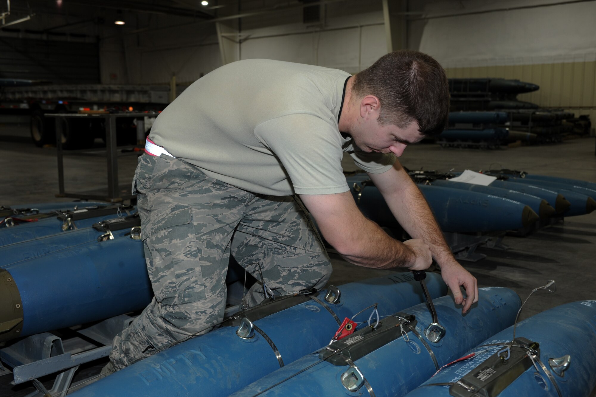 Senior Airman Daniel Deweese, 28th Munitions Squadron conventional maintenance crew chief, checks to ensure the lugs on a bomb dummy unit-50 are flush during a training session at Ellsworth Air Force Base, S.D., Jan. 19, 2016. The Airmen from the 28th MUNS complete thorough inspections of each unit before sending the munitions off to the next group and it reaches its final destination. (U.S. Air Force photo by Airman 1st Class Denise M. Nevins/Released)