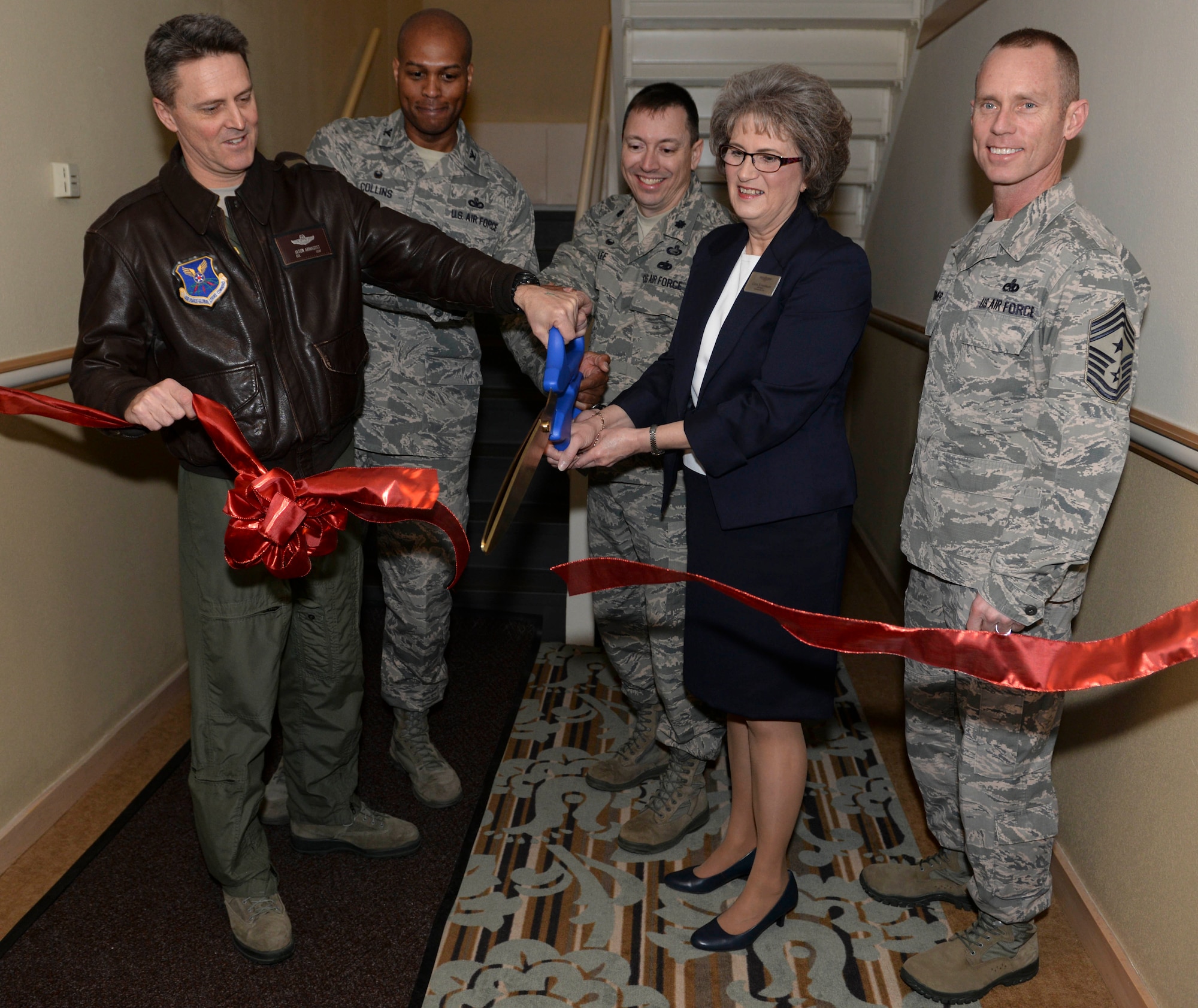 Base leadership joined Cori Esselman, general manager of the Sakakawea Inn, at Minot Air Force Base during a ribbon cutting ceremony to unveil the newly renovated visiting quarters lodging facility Feb. 3, 2016. The former honor guard dormitory, comprised of 30 rooms and 8 suites, is now equipped with big sunny windows, private baths, kitchenettes and is now suitable for guests at all ranks of Minot AFB. (U.S. Air Force photo/Airman 1st Class Jessica Weissman)