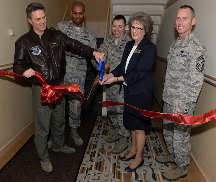 Base leadership joined Cori Esselman, general manager of the Sakakawea Inn, at Minot Air Force Base during a ribbon cutting ceremony to unveil the newly renovated visiting quarters lodging facility Feb. 3, 2016. The former honor guard dormitory, comprised of 30 rooms and 8 suites, is now equipped with big sunny windows, private baths, kitchenettes and is now suitable for guests at all ranks of Minot AFB. (U.S. Air Force photo/Airman 1st Class Jessica Weissman)