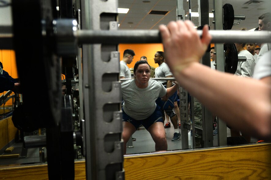 Airman 1st Class Allison De La Porte, a response force member assigned to the 91st Missile Security Forces Squadron from Minot Air Force Base, N.D., squats 115 pounds during the quarterly Top Dog competition Jan. 27, 2016 at the McAdoo Fitness Center. De La Porte was the only female on the seven-member team and she participated in all seven strength and endurance challenges.  (U.S. Air Force photo/Airman 1st Class Jessica Weissman)