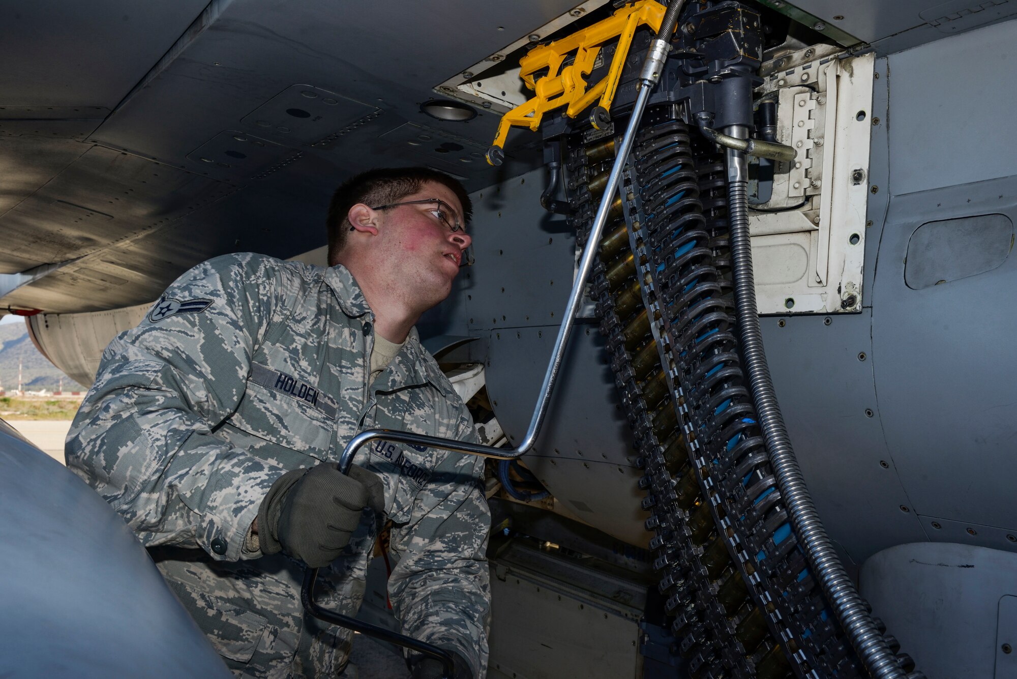 U.S. Air Force Airman 1st Class Austin Holden, a weapons load crew member assigned to the 480th Expeditionary Fighter Squadron, Spangdahlem Air Base, Germany, uses a universal ammunition loading system to load 20 mm practice rounds into an F-16 Fighting Falcon fighter aircraft during a flying training deployment on the flightline at Souda Bay, Greece, Jan. 29, 2016. The inert munitions used during the FTD simulate real conditions the 480th EFS pilots might use when engaging enemy forces. (U.S. Air Force photo by Staff Sgt. Christopher Ruano/Released)
