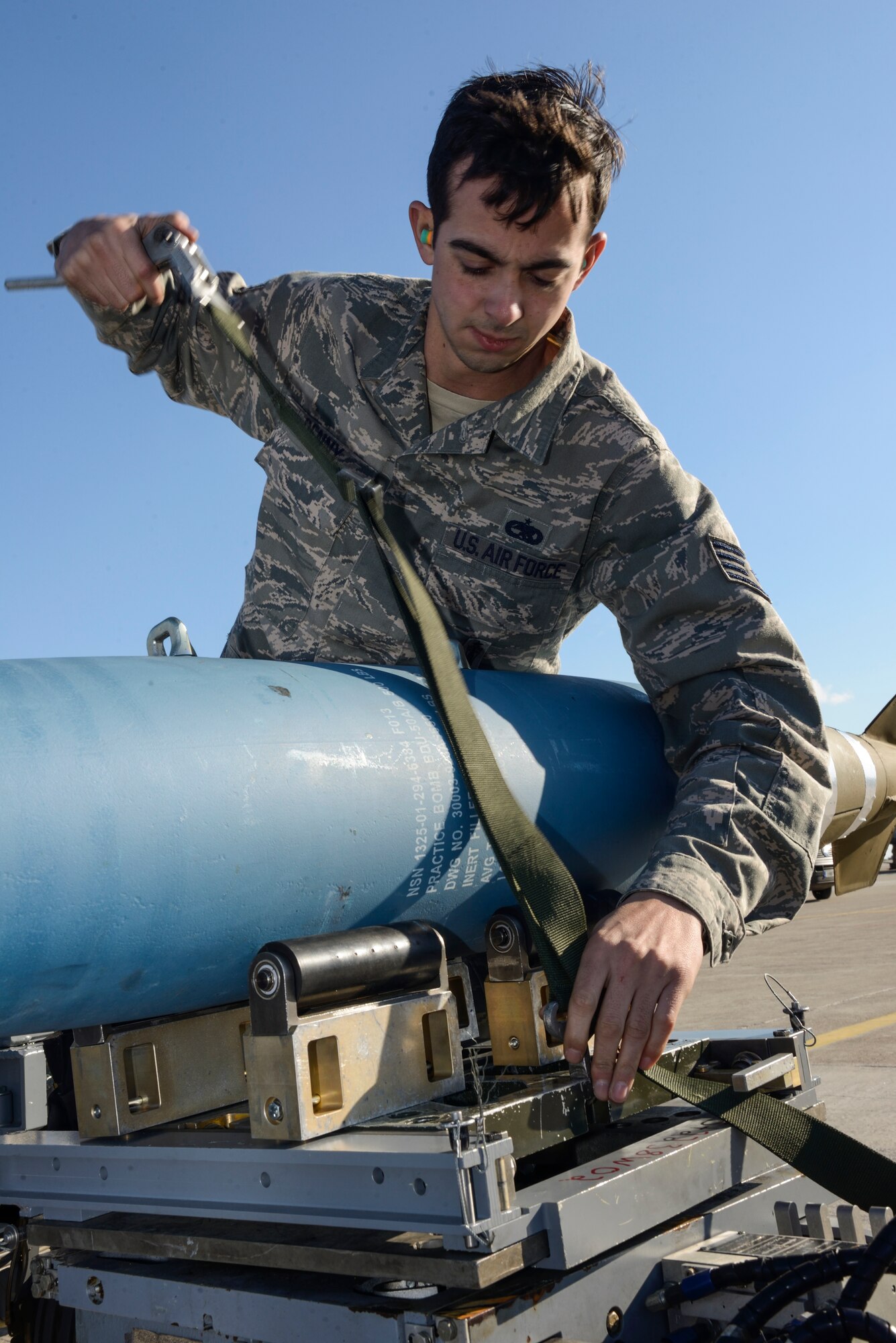 U.S. Air Force Staff Sgt. John Denny, a weapons load crew chief assigned to the 480th Expeditionary Fighter Squadron, Spangdahlem Air Base, Germany, secures a Bomb Drop Unit-50 onto a transport vehicle during a flying training deployment at Souda Bay, Greece, Jan. 29, 2016. Approximately 300 personnel and 18 F-16s from the 52nd Fighter Wing are supporting the FTD as part of U.S. Air Forces in Europe-Air Forces Africa's ‘Forward Ready Now’ stance. (U.S. Air Force photo by Staff Sgt. Christopher Ruano/Released)