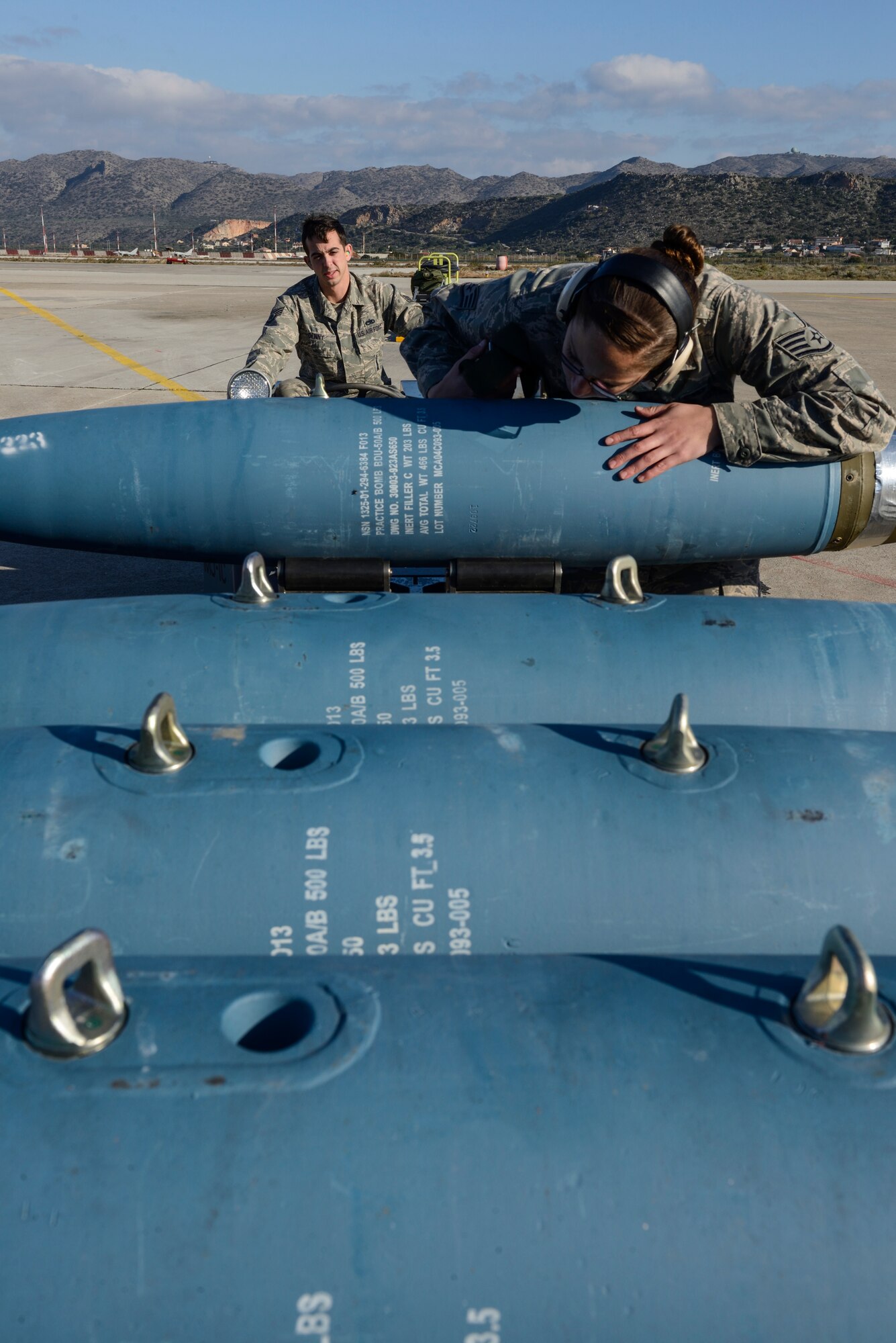 U.S. Air Force Staff Sgt. Faith Olson and Staff Sgt. John Denny, weapons load crew chiefs assigned to the 480th Expeditionary Fighter Squadron, Spangdahlem Air Base, Germany, prep a Bomb Drop Unit-50 for transport during a flying training deployment at Souda Bay, Greece, Jan. 29, 2016. Approximately 300 personnel and 18 F-16s from the 52nd Fighter Wing are supporting the FTD as part of U.S. Air Forces in Europe-Air Forces Africa's ‘Forward Ready Now’ stance. (U.S. Air Force photo by Staff Sgt. Christopher Ruano/Released)