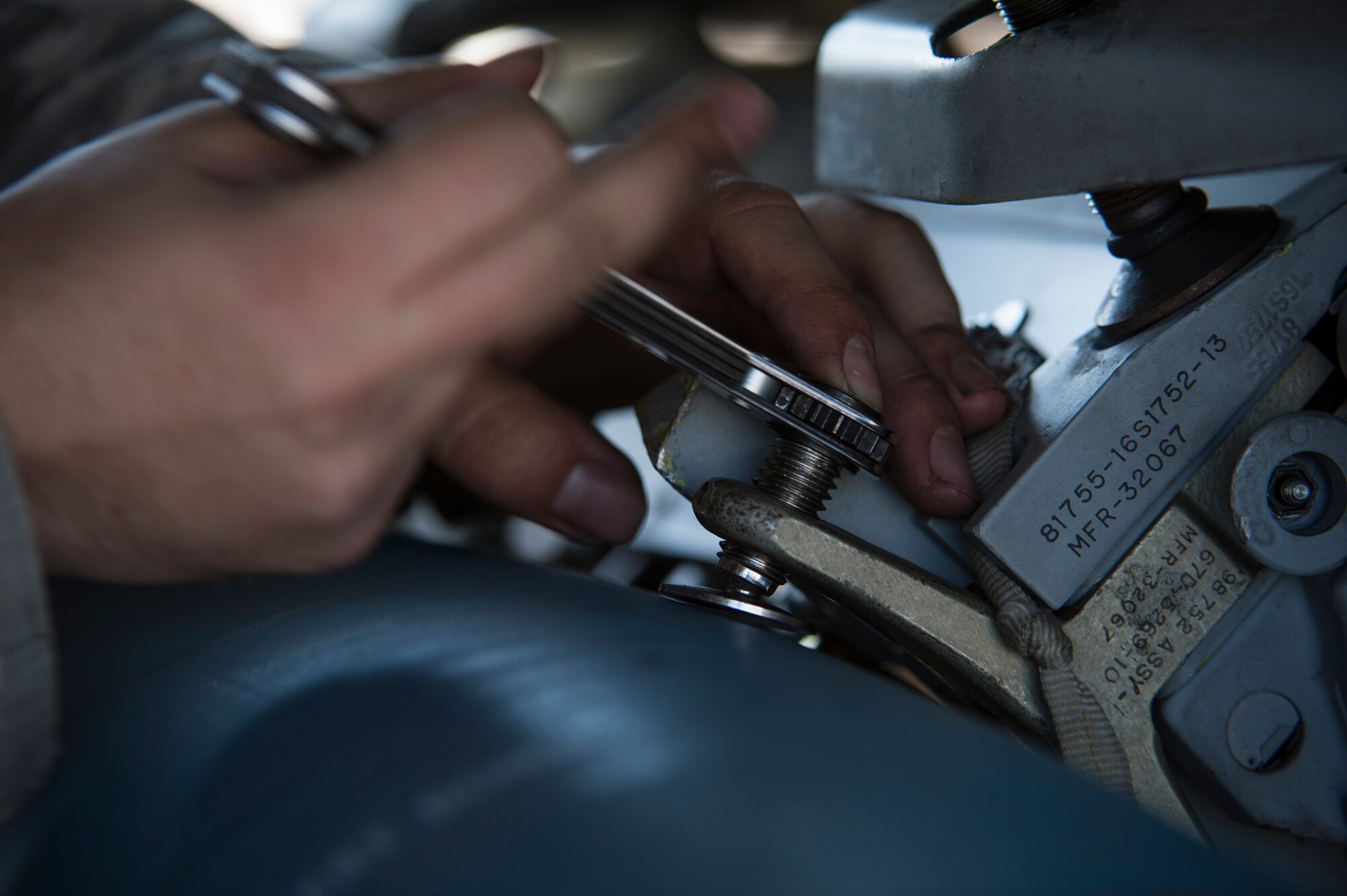 U.S. Air Force Airman 1st Class Austin Holden, a weapons load crew member assigned to the 480th Expeditionary Fighter Squadron, Spangdahlem Air Base, Germany, tightens a securing bolt holding a Bomb Drop Unit-50 to an F-16 Fighting Falcon fighter aircraft bomb rack during a flying training deployment at Souda Bay, Greece, Jan. 29, 2016. This FTD allows both U.S. Air Forces in Europe and the Hellenic air force to extend joint war-fighting capability through operational training. (U.S. Air Force photo by Staff Sgt. Christopher Ruano/Released)